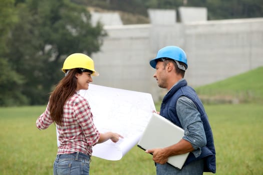 Business people checking plan on construction site