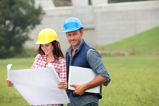Business people checking plan on construction site