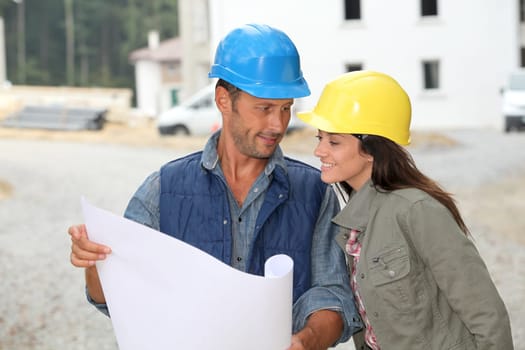 Team of architects checking plans on site