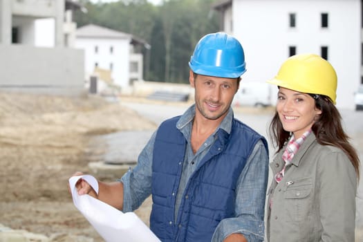 Team of architects checking plans on site