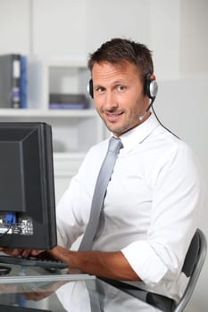 Closeup of businessman in the office with headphones