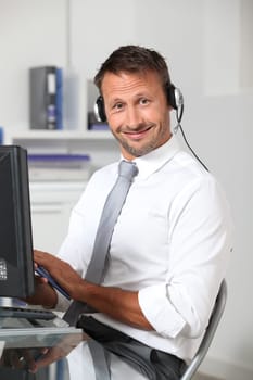 Closeup of businessman in the office with headphones