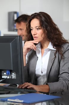 Beautiful woman typing on computer desk