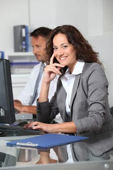 Beautiful woman typing on computer desk