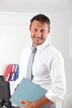 Happy businessman with thumb up in the office