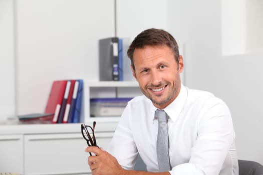Closeup of smiling businessman in the office