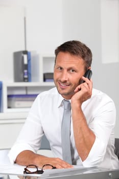 Closeup of businessman talking on the phone in the office