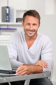 Closeup of employee in the office working on laptop computer