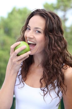 Closeup of woman eating a green apple