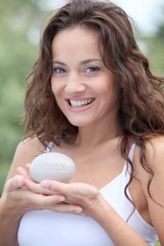 Closeup of beautiful woman holding stone