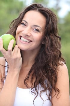 Closeup of woman eating a green apple