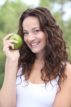 Closeup of woman eating a green apple
