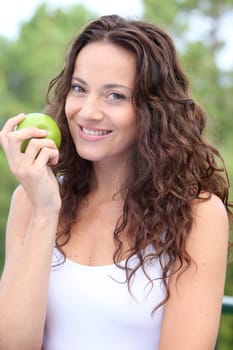 Closeup of woman eating a green apple