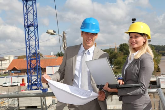Architect and supervisor checking site under construction