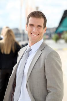 Businessman standing outdoors in the entrance of international fair
