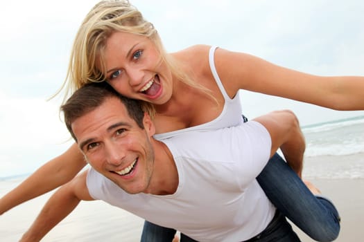 Happy couple enjoying vacation on a sandy beach