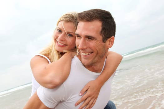 Happy couple enjoying vacation on a sandy beach