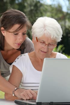 Elderly woman and young woman surfing on internet
