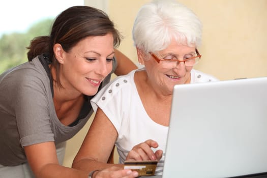 Elderly woman and young woman shopping on internet