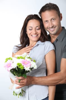 Man giving bunch of flowers to girlfriends