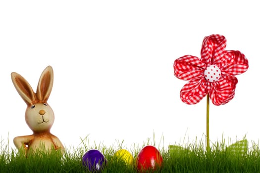 Easter bunny with easter eggs in grass and sto