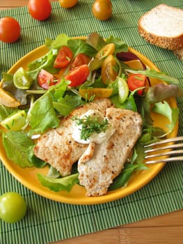 Schnitzel with lettuce and colorful tomatoes