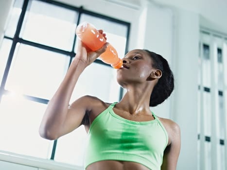 african woman drinking energy drink
