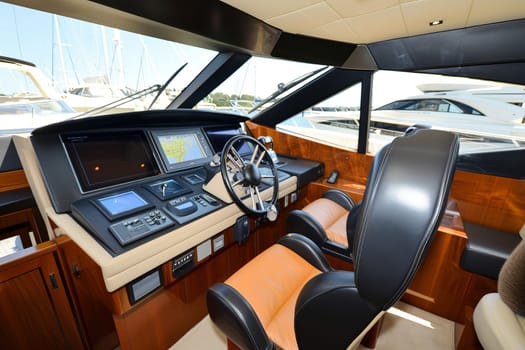 Luxury yacht cockpit with advanced navigation system and plush seats.