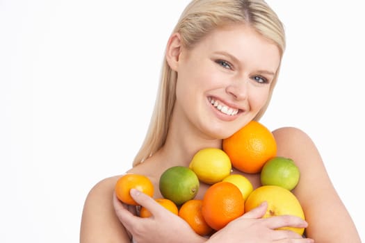 Young Woman Holding Citrus Fruit In Studio