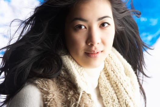 Young Woman Wearing Warm Winter Clothes In Studio