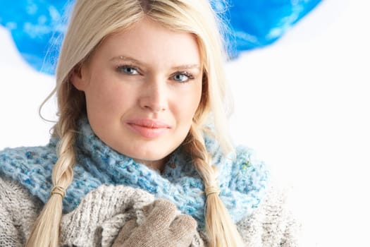 Pretty Young Woman Wearing Warm Winter Clothes In Studio