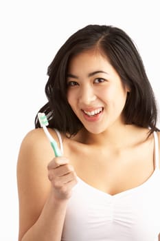 Young Woman Brushing Teeth In Studio