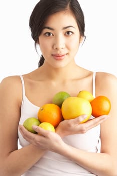 Young Woman Holding Citrus Fruit In Studio
