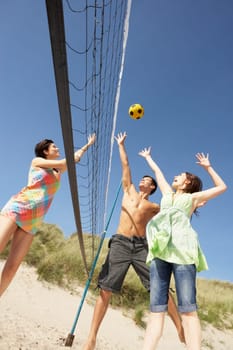 Group Of Teenage Friends Playing Volleyball On Beach