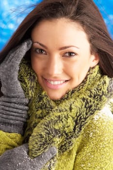 Young Woman Wearing Warm Winter Clothes In Studio