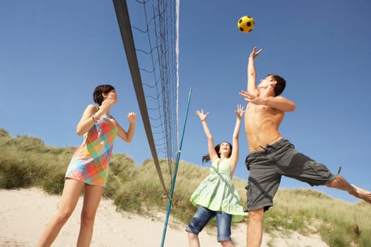 Group Of Teenage Friends Playing Volleyball On Beach