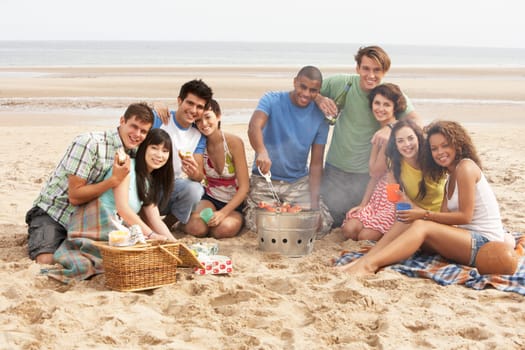 Group Of Friends Enjoying Barbeque On Beach Together