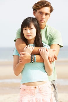 Romantic Young Couple Embracing On Beach