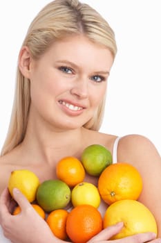 Young Woman Holding Citrus Fruit In Studio