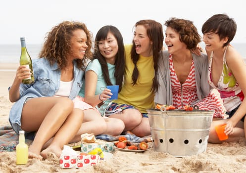 Group Of Girls Enjoying Barbeque On Beach Together