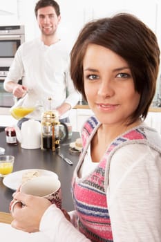 Young Couple Preparing Breakfast In Modern Kitchen