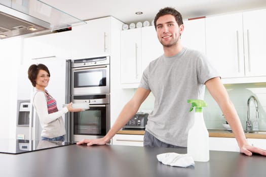 Young Couple Cleaning Cleaning Modern Kitchen