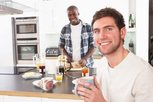 Two Young Men Preparing Breakfast In Modern Kitchen