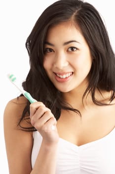 Young Woman Brushing Teeth In Studio