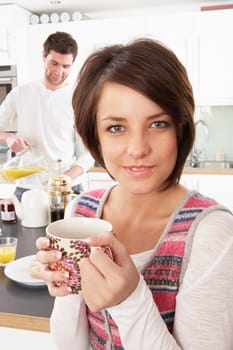 Young Couple Preparing Breakfast In Modern Kitchen