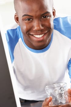Young Man Using Computer In Modern Kitchen