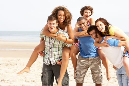 Group Of Friends Running Along Beach Together