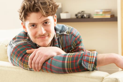 Man Relaxing On Sofa At Home