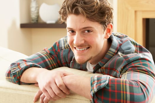 Man Relaxing On Sofa At Home