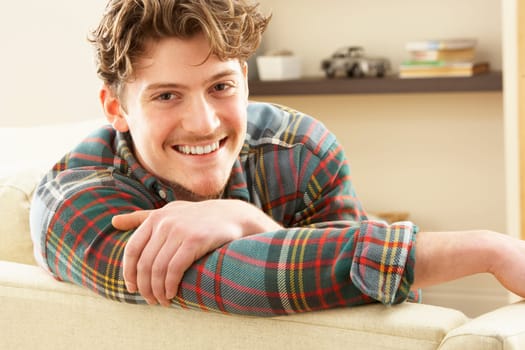 Man Relaxing On Sofa At Home